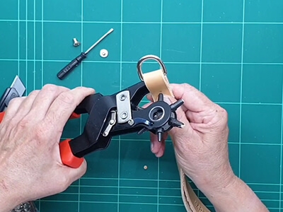 Step 5 Fold læderet omkring d-ring og lav hul til postskruen